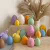 A cheerful assortment of colorful egg candles on a table, perfect for celebrating a joyful occasion.