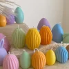A cheerful assortment of colorful egg candles on a table, perfect for celebrating a joyful occasion.