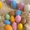 A cheerful assortment of colorful egg candles on a table, perfect for celebrating a joyful occasion.
