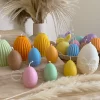 A cheerful assortment of colorful egg candles on a table, perfect for celebrating a joyful occasion.