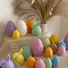 A cheerful assortment of colorful egg candles on a table, perfect for celebrating a joyful occasion.