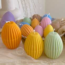 A cheerful assortment of colorful egg candles on a table, perfect for celebrating a joyful occasion.