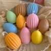 A cheerful assortment of colorful egg candles on a table, perfect for celebrating a joyful occasion.