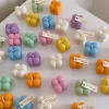 A collection of colorful candles labeled with personalized tags, alongside mini baby bubble candles for special events.