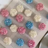 A book with an assortment of colorful candles on it, highlighting a Mini Peony Bud Candle, perfect for gifting at special events.