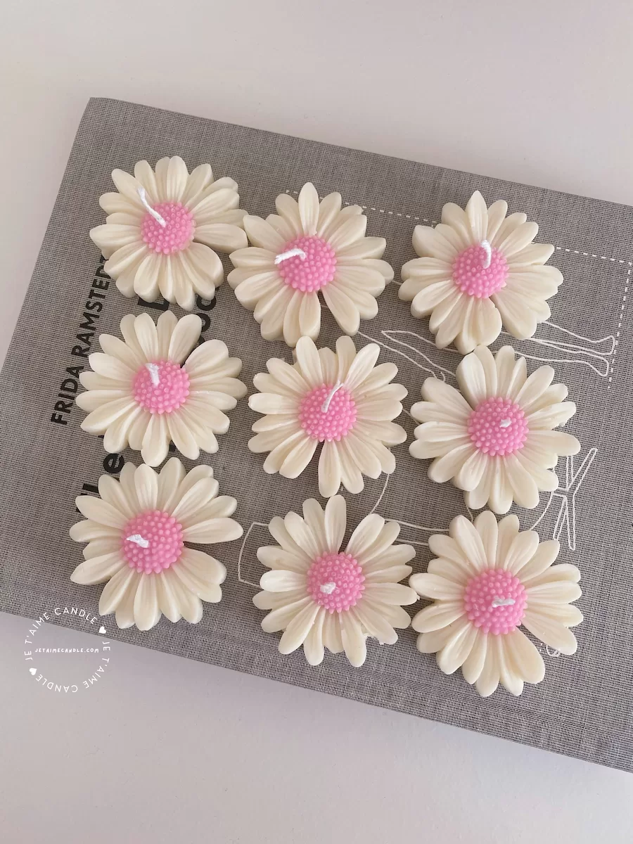 Set of handmade daisy-shaped candles with white petals and pink centers, displayed on a fabric surface – perfect for wedding favors, bridal shower gifts, or spring party decorations.