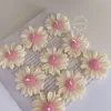 Set of handmade daisy-shaped candles with white petals and pink centers, displayed on a fabric surface – perfect for wedding favors, bridal shower gifts, or spring party decorations.