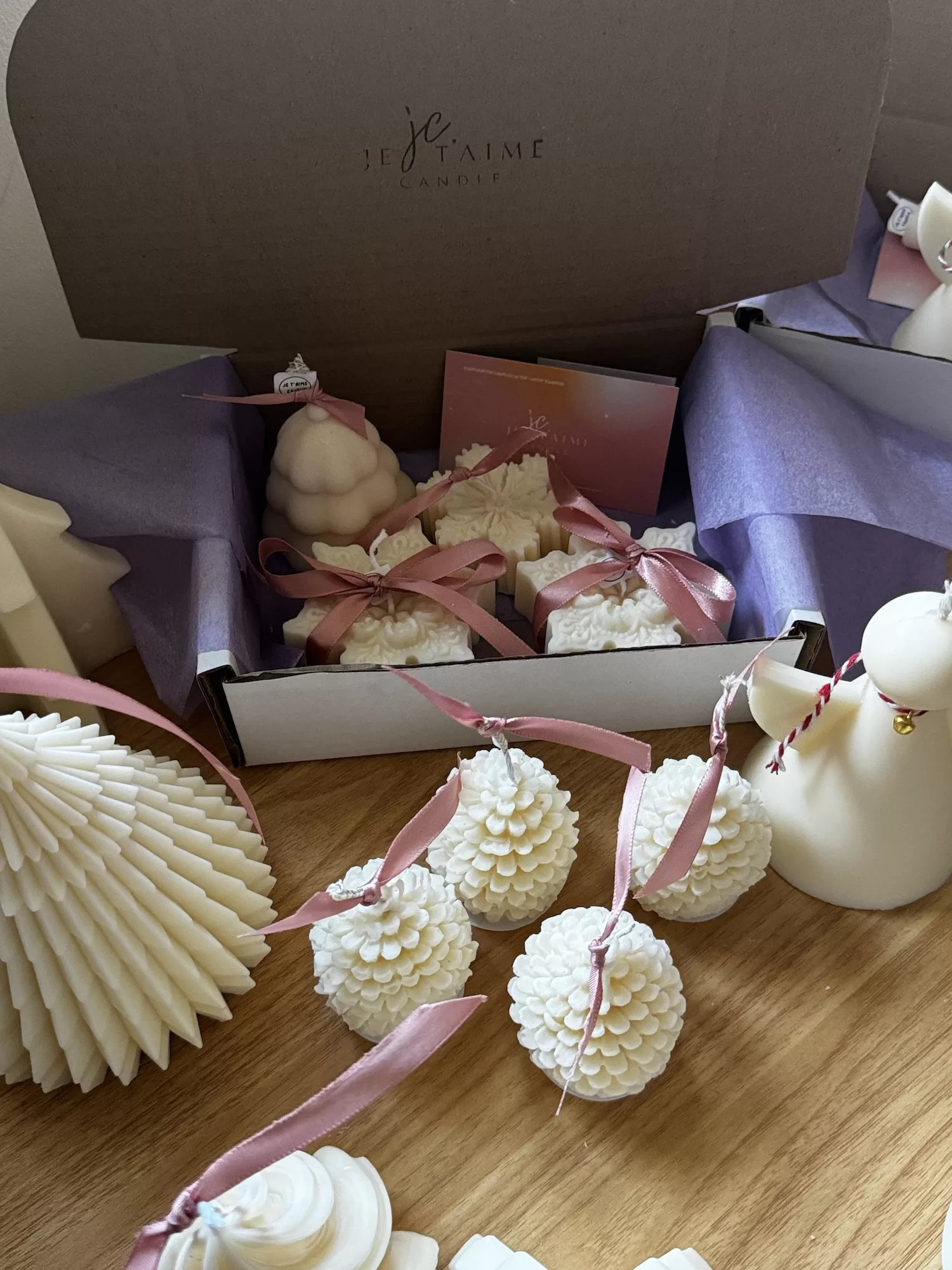 A white candle box beautifully finished with a ribbon, highlighting its appeal as a thoughtful gift option.