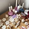 A beautifully set table featuring an array of candles and various decorative elements for a festive ambiance.