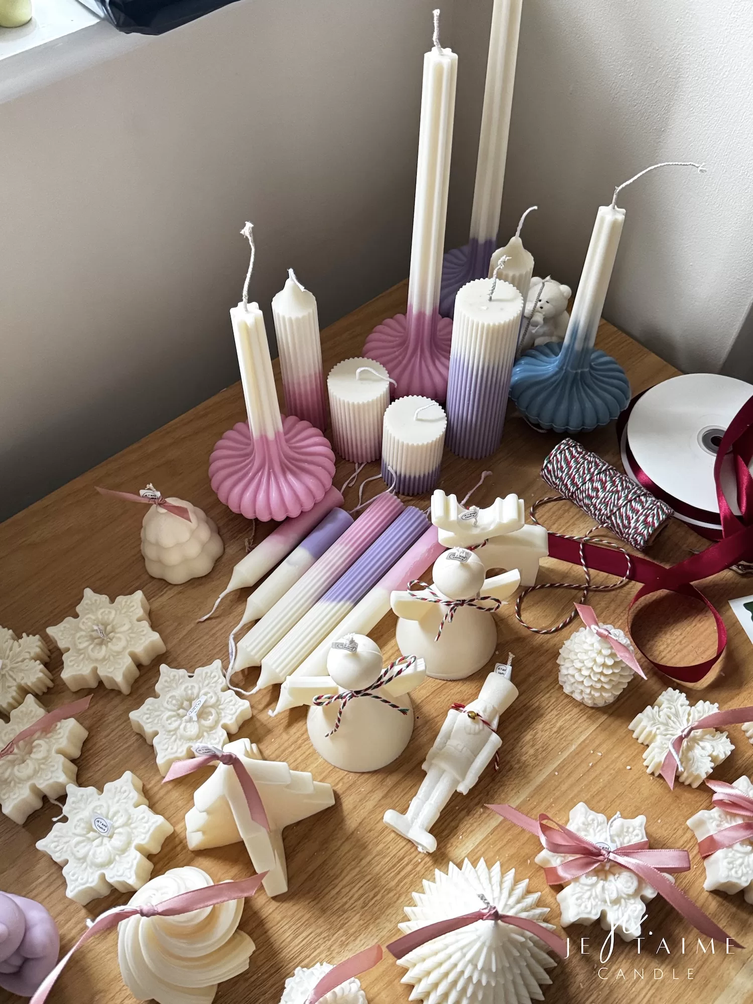 A beautifully set table featuring an array of candles and various decorative elements for a festive ambiance.