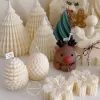 A table adorned with a variety of colorful Christmas decorations, including Christmas Tree Candles, Pinecone Shaped Candle, Angel Candle, Snowflake Christmas Candle, Town House Candle, Gingerbread Men Candle, Deer Candle.