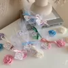 Colorful rose candles in pink, blue, yellow, and white, wrapped in white organza bags with personalized 'Thank You' tags for Amy's baby shower on 12/01/2024, displayed with pampas grass decor in the background