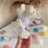 Colorful rose candles in pink, blue, yellow, and white, wrapped in white organza bags with personalized 'Thank You' tags for Amy's baby shower on 12/01/2024, displayed with pampas grass decor in the background