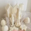 A beautifully set table featuring an array of candles and various decorative elements for a festive ambiance.