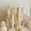 A beautifully set table featuring an array of candles and various decorative elements for a festive ambiance.