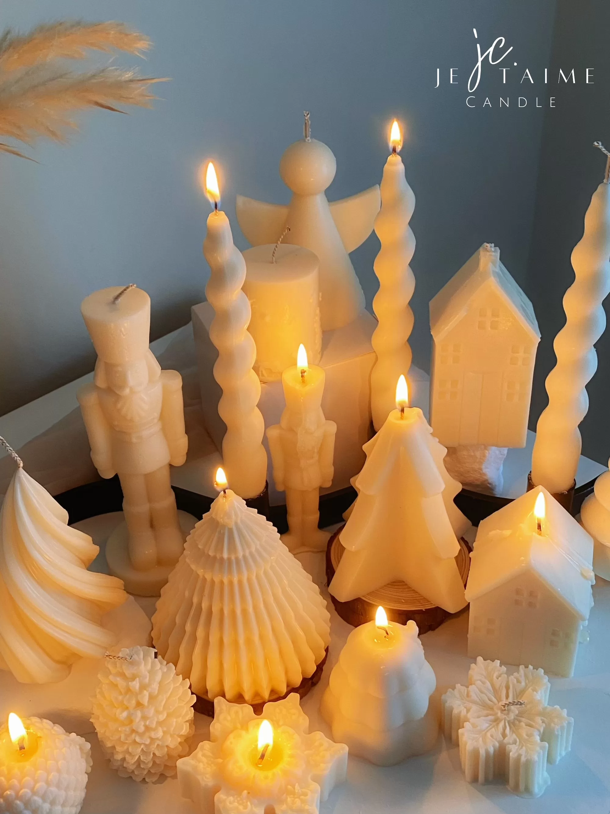 Set of white decorative candles shaped like Christmas trees, nutcrackers, angel, pinecones, and snowflakes, elegant holiday decor and gift.