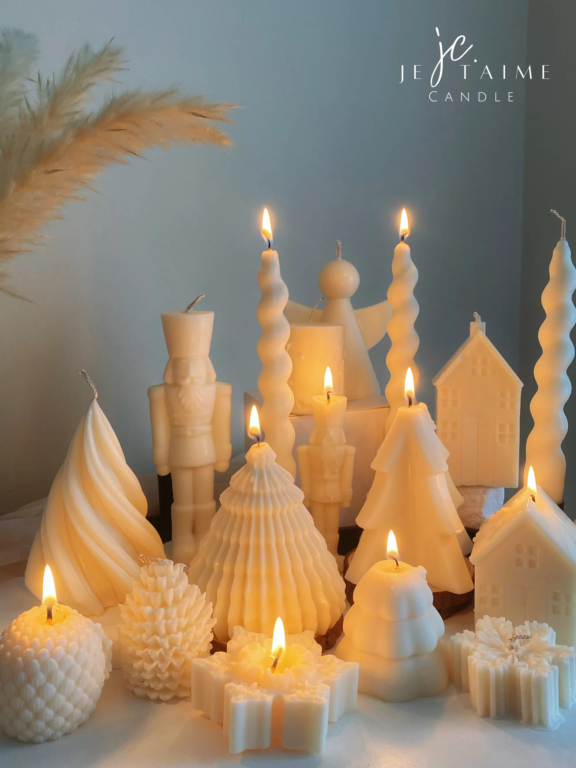 Set of white decorative candles shaped like Christmas trees, nutcrackers, angel, pinecones, and snowflakes, elegant holiday decor and gift.
