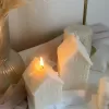 Handmade soy wax house-shaped candles in creamy white, styled with bubble cube candle and decorative accents, perfect for minimalist home décor, cozy table styling, wedding centerpieces, or unique handmade gift ideas.