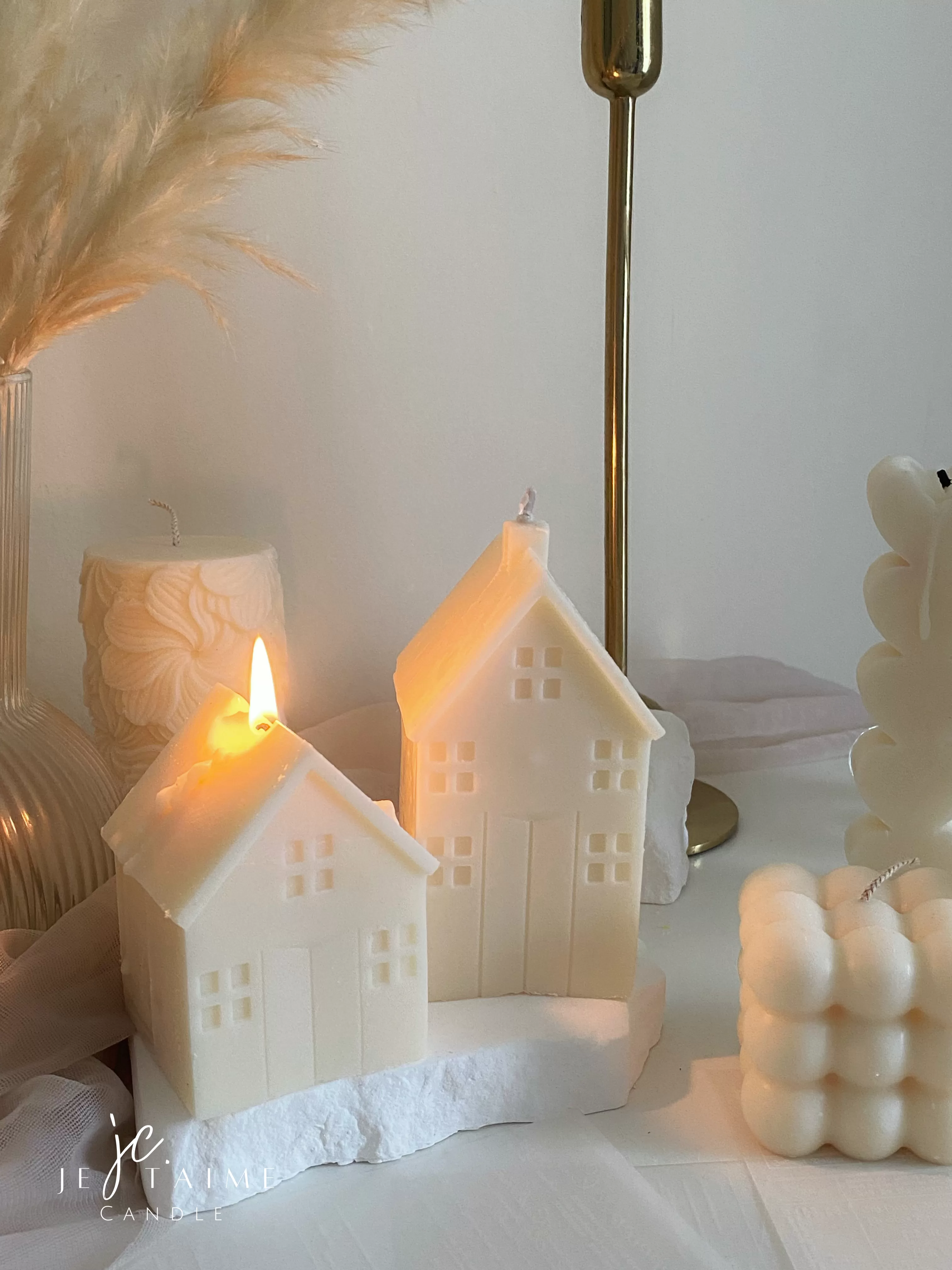 Handmade soy wax house-shaped candles in creamy white, styled with bubble cube candle and decorative accents, perfect for minimalist home décor, cozy table styling, wedding centerpieces, or unique handmade gift ideas.