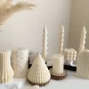 Handmade aesthetic candle in ivory soy wax with a modern fluted design, displayed on a white stone base with pampas grass and other decorative candles in the background. This sculptural column candle is perfect for minimalist home décor, wedding centerpieces, or as a unique handmade gift, adding timeless elegance and modern style to any space.