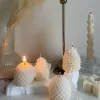 Assorted handmade Christmas candles in festive shapes including Pinecone, snowflakes, taper candle, displayed together in holiday-themed colors.