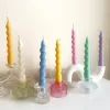 Set of colorful spiral twist soy wax taper candles in pastel green, pink, lavender, blue, yellow, and cream, displayed in clear glass holders, perfect for dinner table decor, wedding centerpieces, and modern home styling.