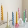 Set of colorful spiral twist soy wax taper candles in pastel green, pink, lavender, blue, yellow, and cream, displayed in clear glass holders, perfect for dinner table decor, wedding centerpieces, and modern home styling.