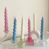 Set of colorful spiral twist soy wax taper candles in pastel pink, blue and cream, displayed in clear glass holders, perfect for dinner table decor, wedding centerpieces, and modern home styling.