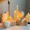 Handmade soy wax decorative candles in creamy white, including ribbed pillar, bubble cube, spiral twist, heart-shaped, bear-shaped, and swirl ball designs, lit for cozy aesthetic home décor, wedding table decoration, or unique gift ideas.