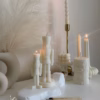Handmade soy wax decorative candles in creamy white, including christmas nutcracker, bubble designs, lit for cozy aesthetic home décor, christmas gift, wedding table decoration, or unique gift ideas.